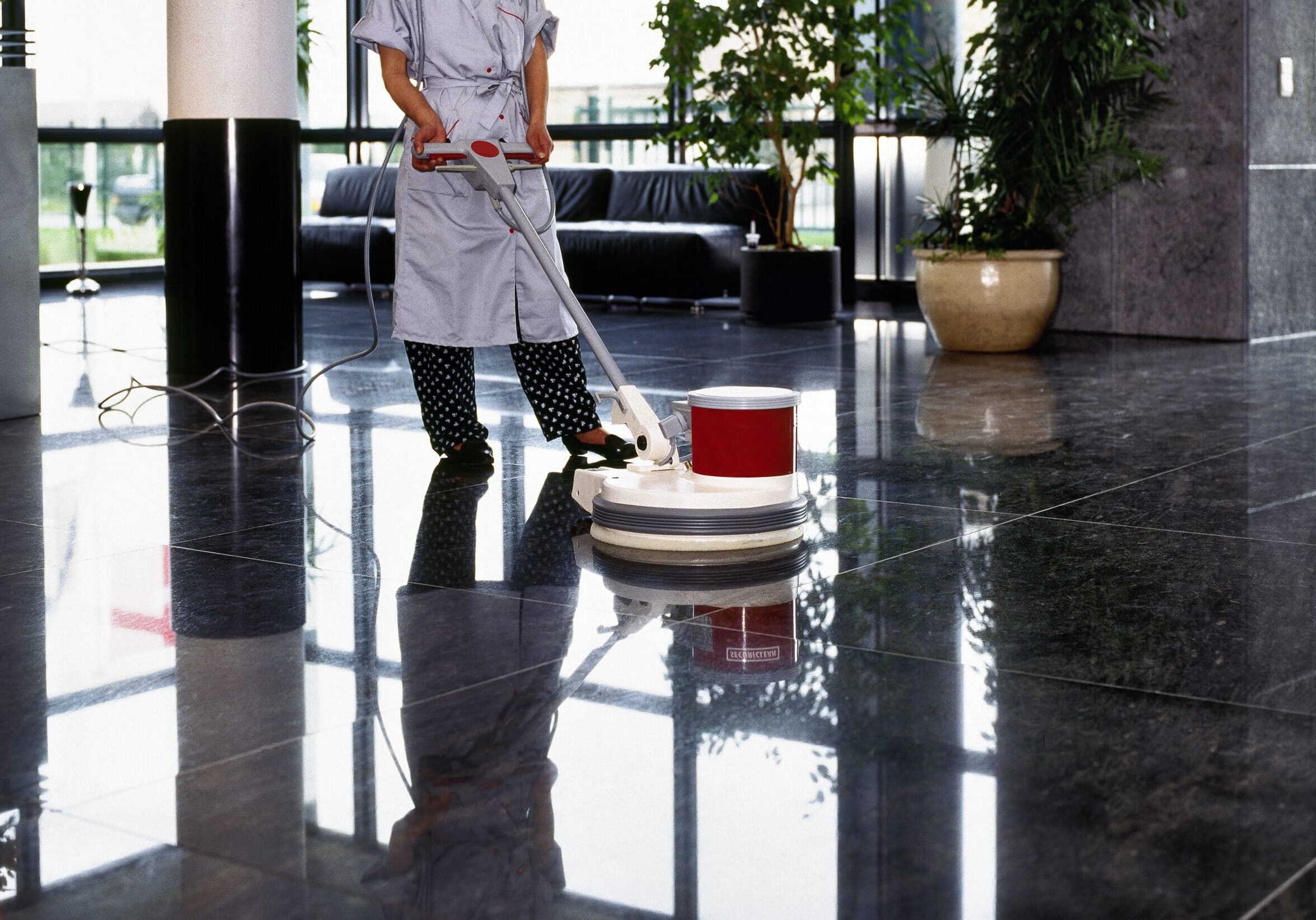 Adult cleaner maid woman with uniform cleaning corridor pass floor